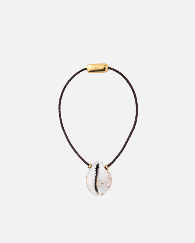 A beige Tiger Cowrie shell necklace with a gold-colored clasp, displayed against a white background.